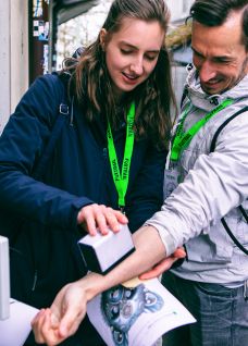Two people solve an interactive puzzle station in the city together as part of a Foxtrail outdoor programme. @FoxTrail Fox Trail Thun