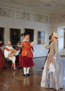 Darsteller in historischen Kostümen inszenieren eine Führung in einem prunkvollen Saal – inspirierendes Rahmenprogramm für Events in der Region Thunersee. ©Schloss Spiez Historische Kostümführung mit Schauspielern in einem barocken Saal