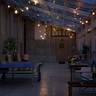 A stylish event venue with fairy lights and lounge furniture in the Lake Thun region