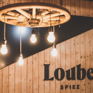 Warm vintage lighting and wooden panelling in the function room 