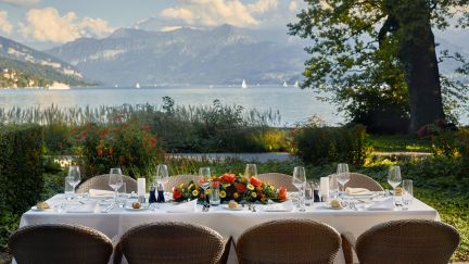 A festively laid table on Lake Thun with views of the Alps and sailing boats