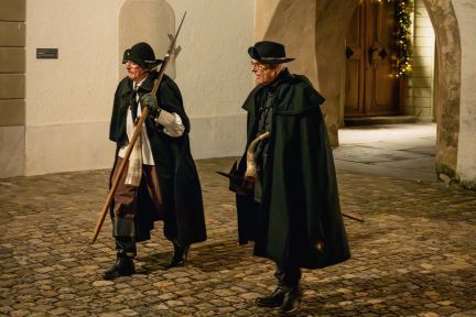 Nachtw&auml;chter in historischer Altstadtgasse mit Laterne und Hund