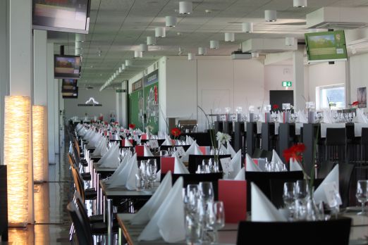 Bankettbestuhlung in modernem Eventraum mit gedeckten Tischen