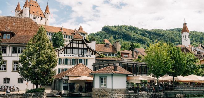 The Hotel Krone on the banks of the Aare in Thun, with Thun Castle in the background