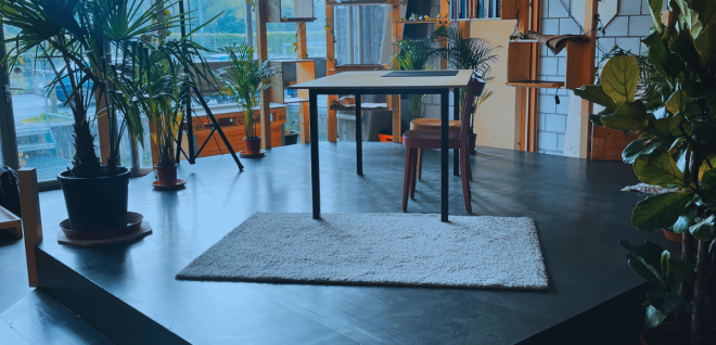 Creative meeting room with plants, a stage and a large window front