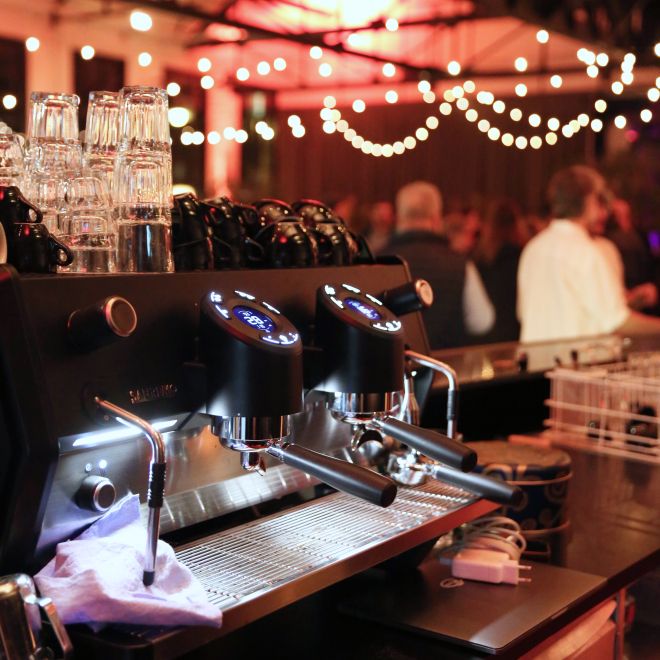 Espresso machine at the bar with fairy lights in an atmospheric event venue